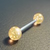Piercing langue orange paillette